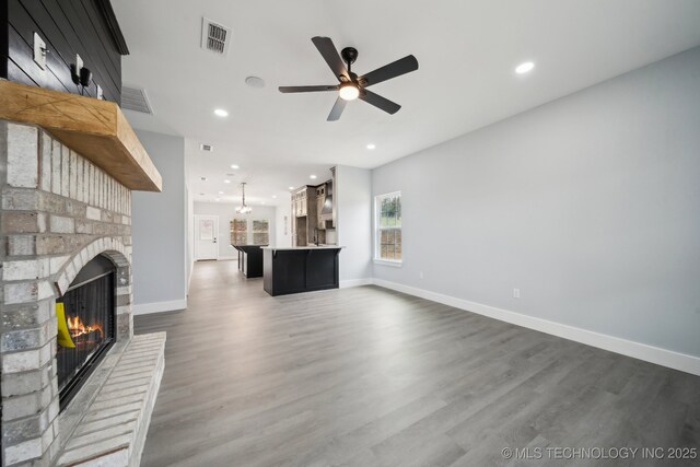 7890 N Oak Dr, Beggs, OK 74421 - unfurnished living room featuring ceiling fan, baseboards, a brick fireplace, and recessed lighting