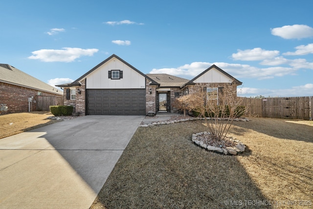 view of front of property with brick siding, board and batten siding, fence, a garage, and driveway