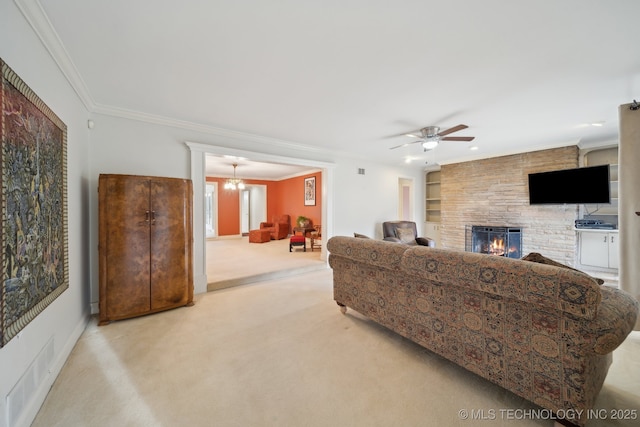 living room featuring crown molding, carpet flooring, a fireplace, and visible vents