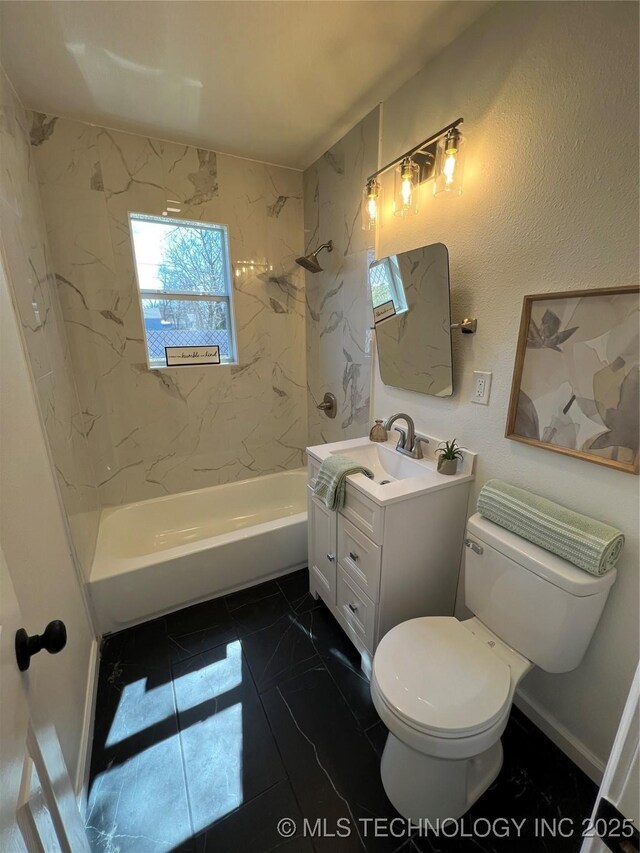 bathroom featuring toilet, vanity, baseboards, marble finish floor, and shower / bathing tub combination