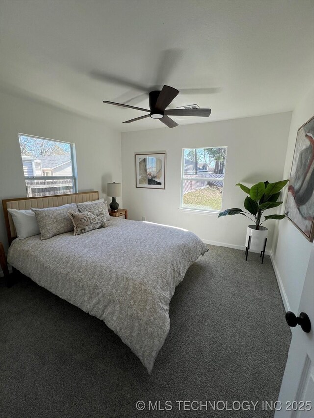 bedroom featuring ceiling fan, carpet flooring, and baseboards