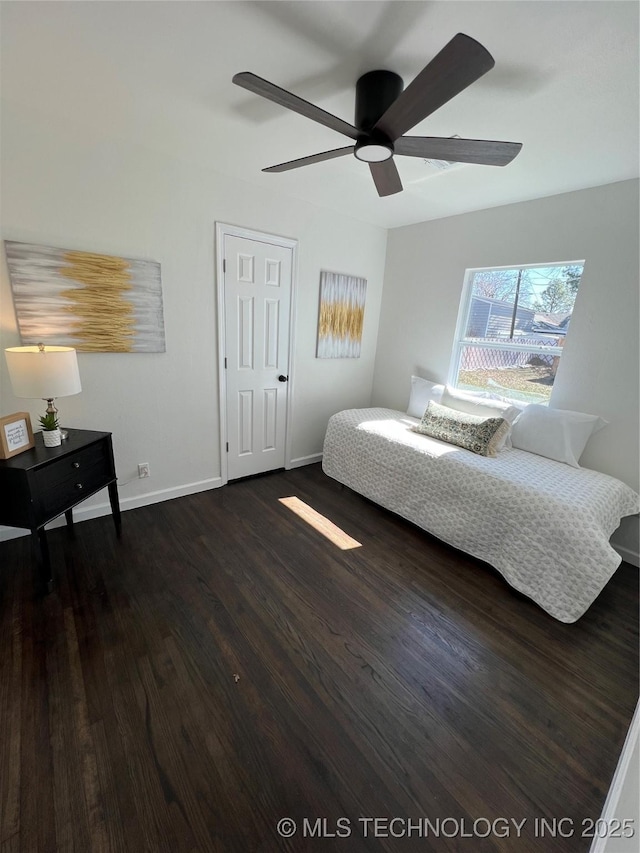 bedroom with ceiling fan, baseboards, and wood finished floors