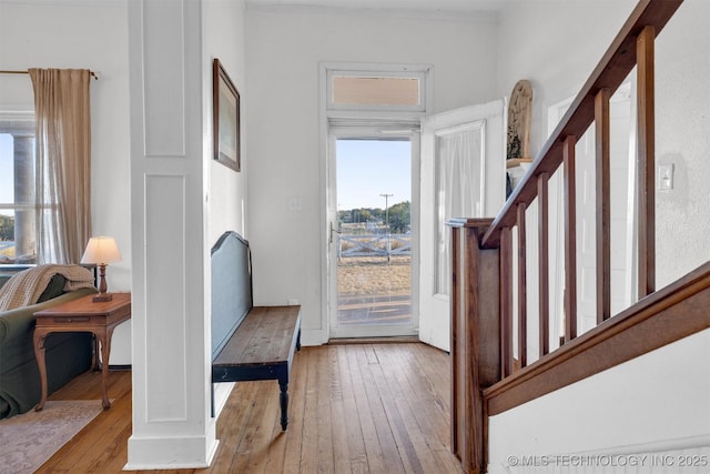 entryway featuring hardwood / wood-style flooring and stairs