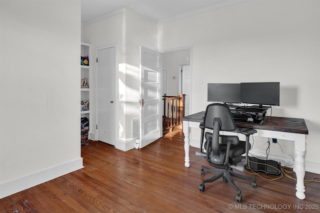 office area with built in features, hardwood / wood-style flooring, baseboards, and crown molding