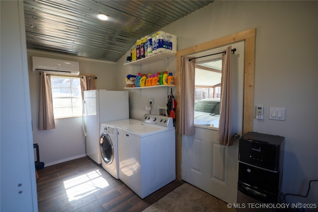 laundry area with a wealth of natural light, an AC wall unit, laundry area, and washer and clothes dryer