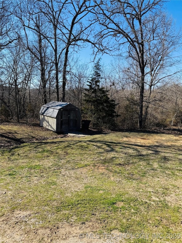 view of yard featuring a storage shed and an outbuilding