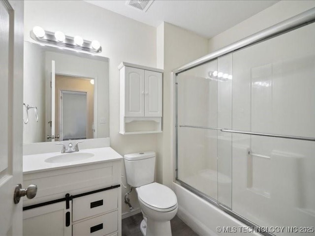 full bath with toilet, vanity, and visible vents