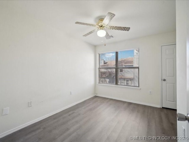 unfurnished room with ceiling fan, baseboards, and wood finished floors