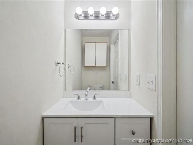 bathroom featuring toilet and vanity