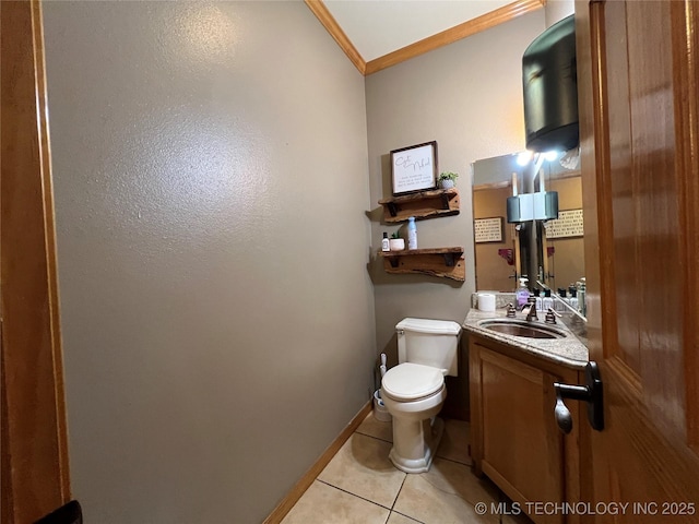 half bath with toilet, vanity, baseboards, ornamental molding, and tile patterned floors