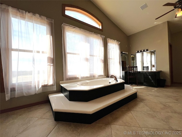 bathroom with lofted ceiling, ceiling fan, a garden tub, visible vents, and tile patterned floors