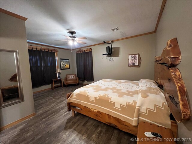 bedroom featuring ceiling fan, wood finished floors, visible vents, baseboards, and ornamental molding