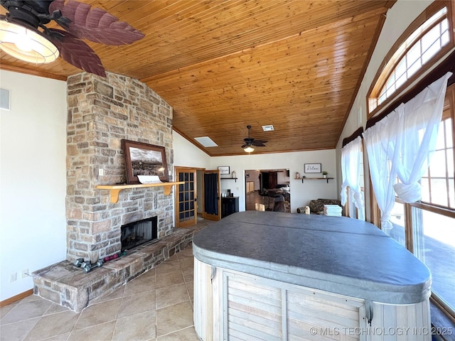 kitchen featuring a fireplace, vaulted ceiling, ceiling fan, tile patterned flooring, and wooden ceiling