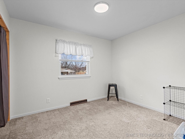 interior space featuring carpet flooring, visible vents, and baseboards