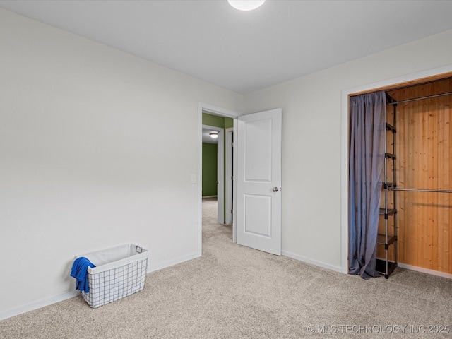 unfurnished bedroom featuring carpet flooring and baseboards