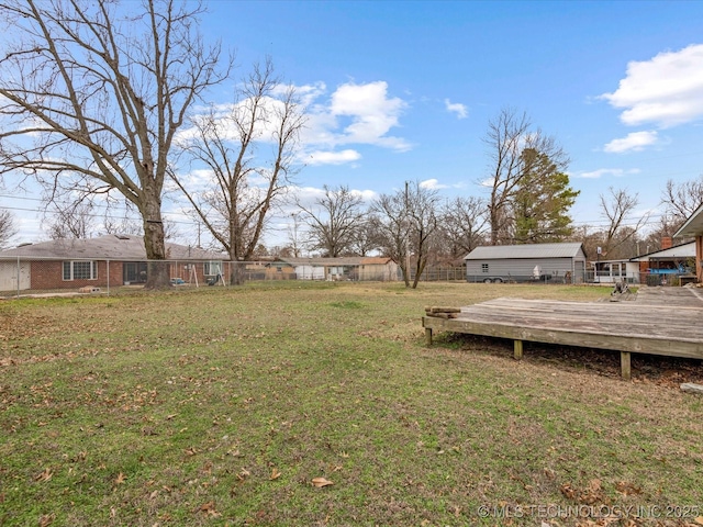 view of yard featuring fence and a wooden deck