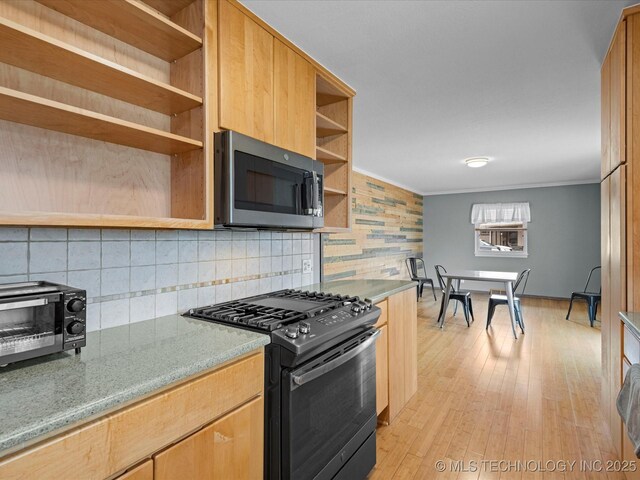 kitchen featuring crown molding, open shelves, stainless steel microwave, light wood-style floors, and black range with gas cooktop