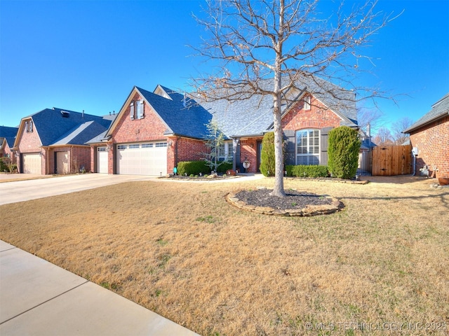 view of front of home featuring a front yard, brick siding, driveway, and fence