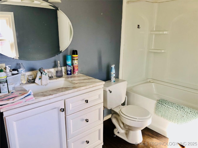 bathroom featuring bathing tub / shower combination, vanity, toilet, and wood finished floors