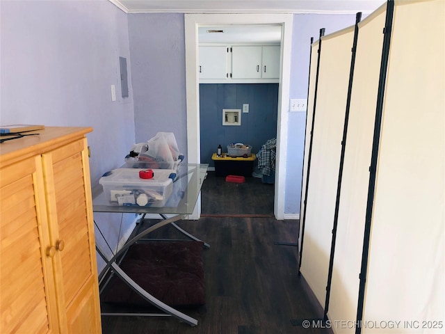 interior space with washer hookup, cabinet space, and dark wood finished floors