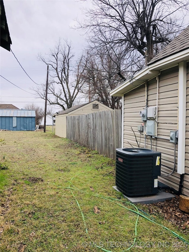 view of yard featuring fence and cooling unit