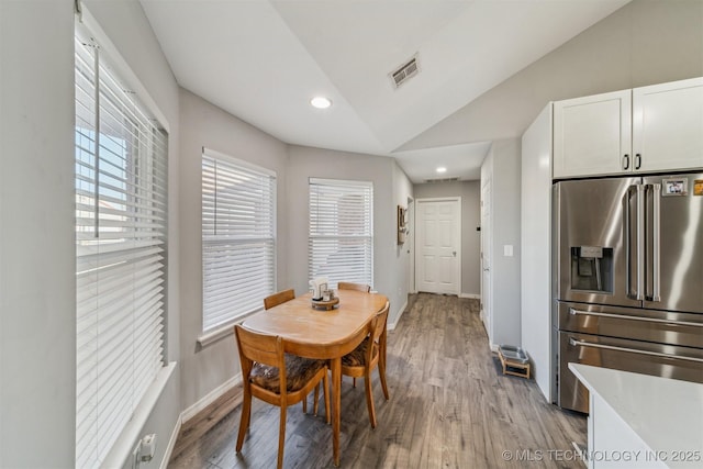 dining area with recessed lighting, visible vents, baseboards, vaulted ceiling, and light wood-style floors