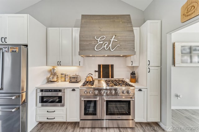 kitchen with white cabinetry, stainless steel appliances, and light countertops