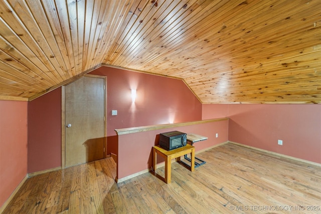 additional living space featuring wood ceiling, baseboards, vaulted ceiling, and wood finished floors