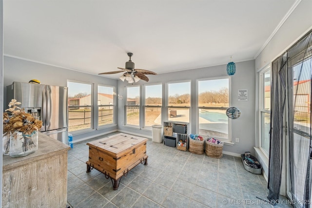 sunroom featuring a ceiling fan