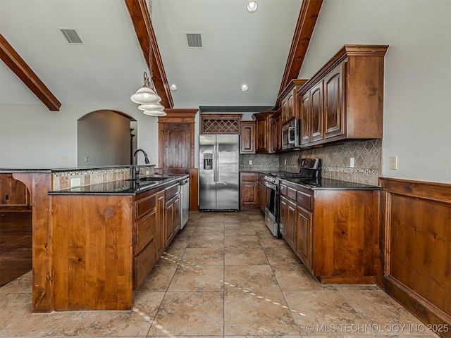 kitchen with visible vents, beam ceiling, a sink, appliances with stainless steel finishes, and backsplash