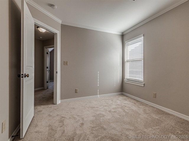 unfurnished bedroom featuring carpet flooring, baseboards, and ornamental molding