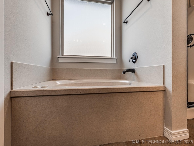 bathroom featuring a garden tub