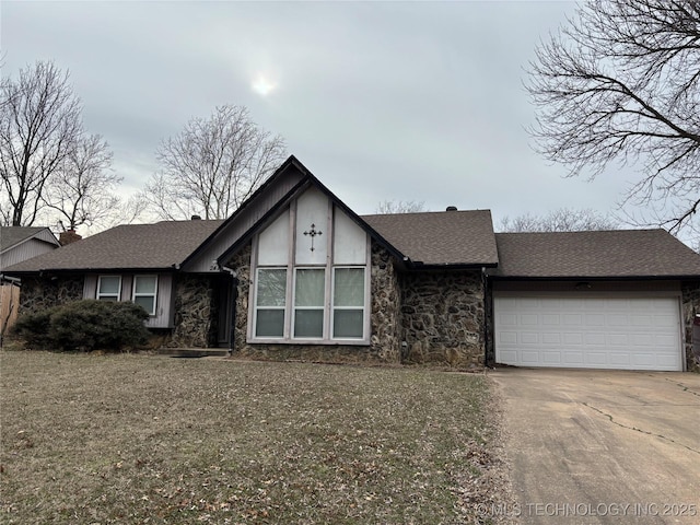 view of front of property with a garage, stone siding, roof with shingles, and concrete driveway