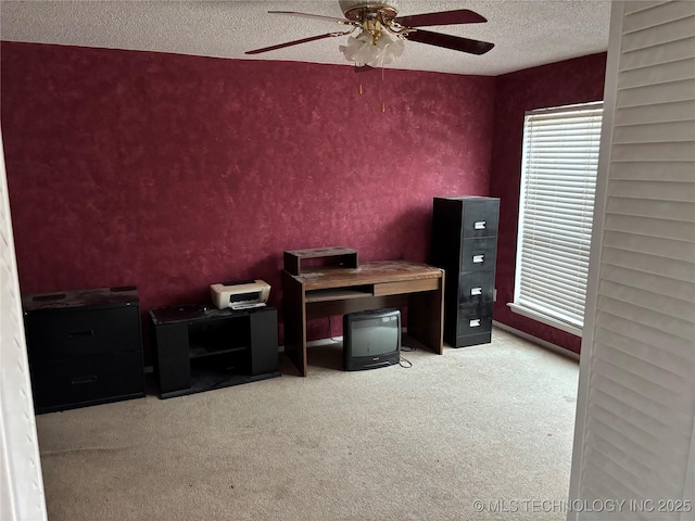 unfurnished office featuring a textured ceiling, carpet flooring, and a ceiling fan