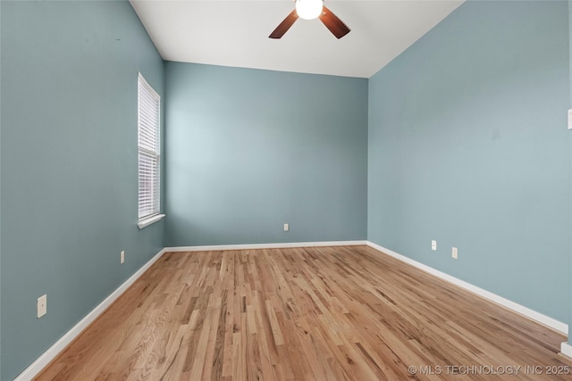 unfurnished room featuring a ceiling fan, baseboards, and wood finished floors