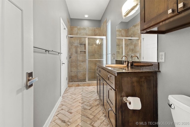 full bathroom with toilet, a shower stall, and vanity