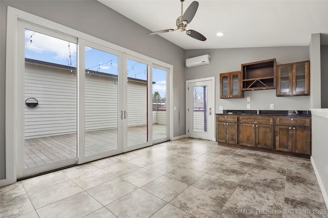 kitchen with open shelves, dark countertops, lofted ceiling, glass insert cabinets, and a wall mounted air conditioner