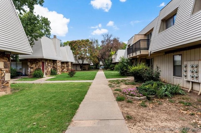 view of home's community with a lawn