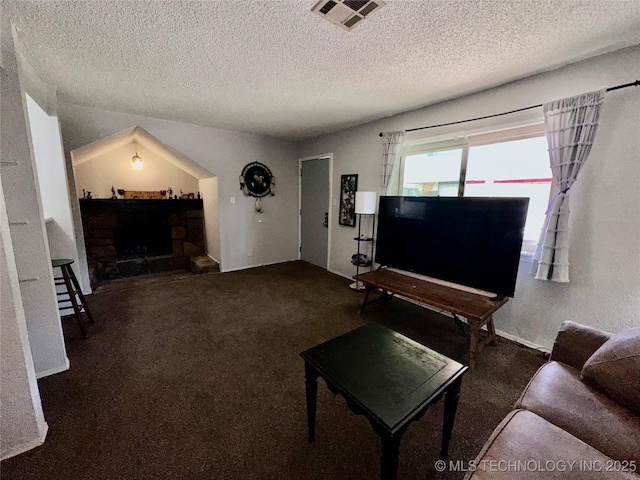 carpeted living area featuring a textured ceiling, a fireplace, and visible vents