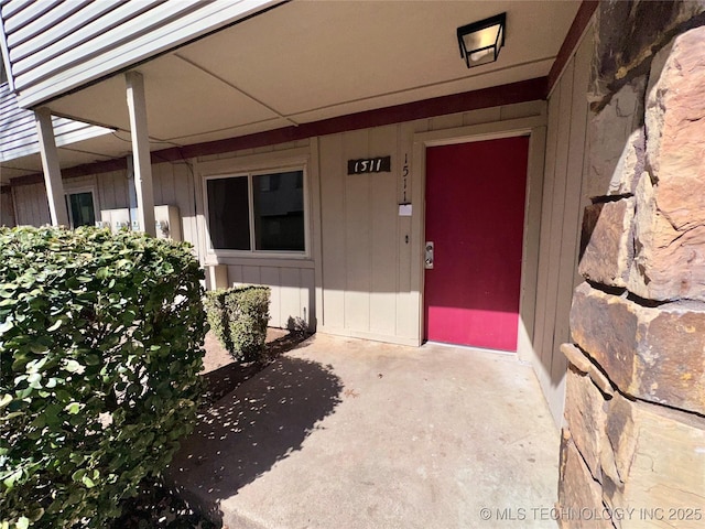 doorway to property featuring board and batten siding