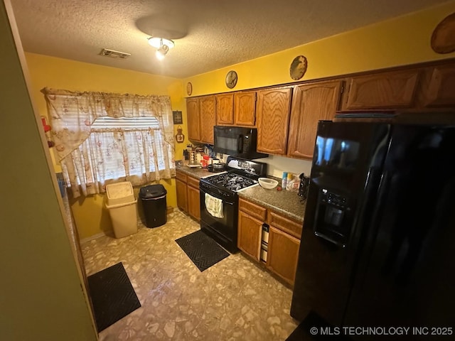 kitchen with a textured ceiling, light floors, visible vents, black appliances, and brown cabinetry