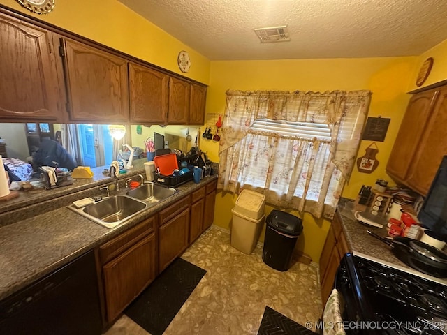 kitchen with visible vents, brown cabinets, a textured ceiling, black appliances, and a sink