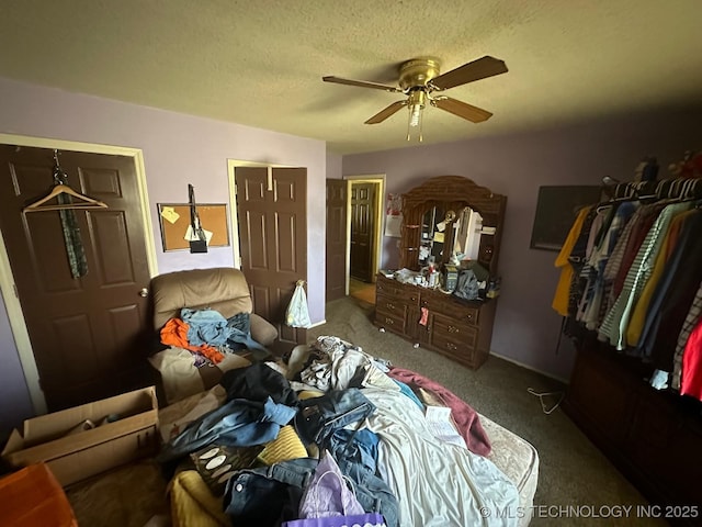 carpeted bedroom featuring a ceiling fan and a textured ceiling