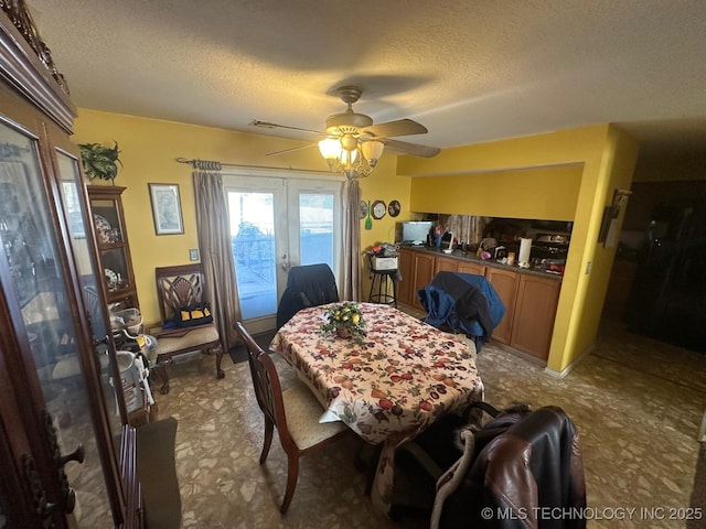 dining room with a ceiling fan, french doors, and a textured ceiling