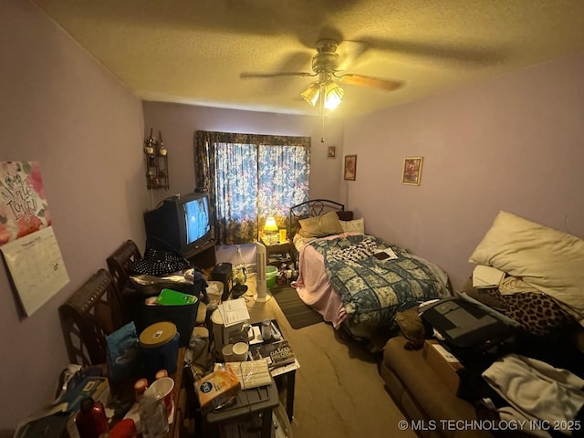 bedroom with ceiling fan and a textured ceiling