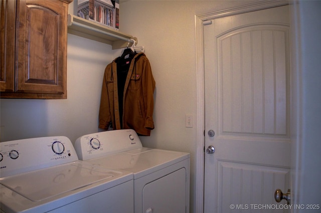 washroom with washing machine and dryer and cabinet space