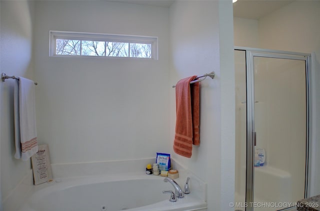 full bathroom featuring a shower stall and a whirlpool tub