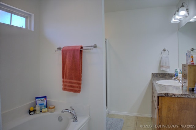 full bathroom featuring a garden tub, vanity, a shower stall, baseboards, and tile patterned floors