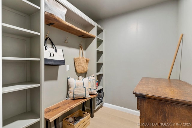 mudroom with wood finished floors and baseboards