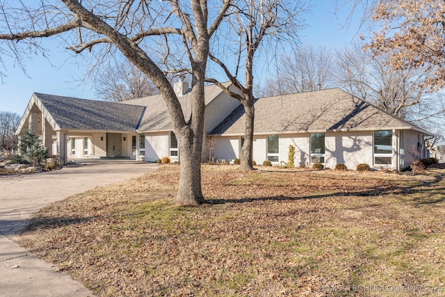 view of front facade with concrete driveway and brick siding